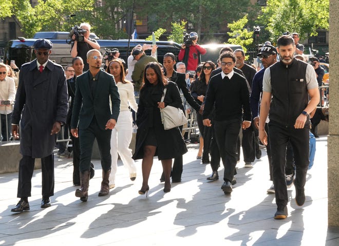 Quincy Brown and Justin Combs walk with other members of the Combs family as they arrive at federal court on May 12, 2025, in New York.